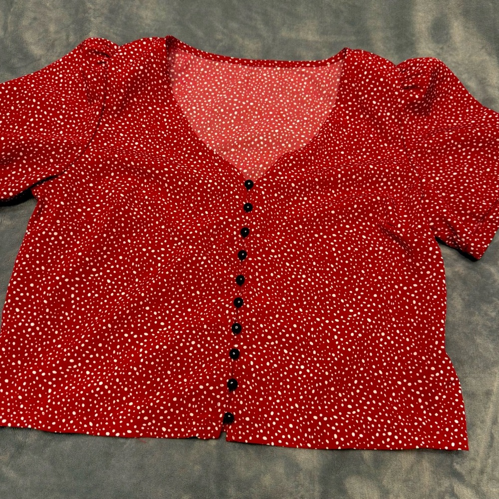 Red polka dot shirt. About pant waist length.Never worn
